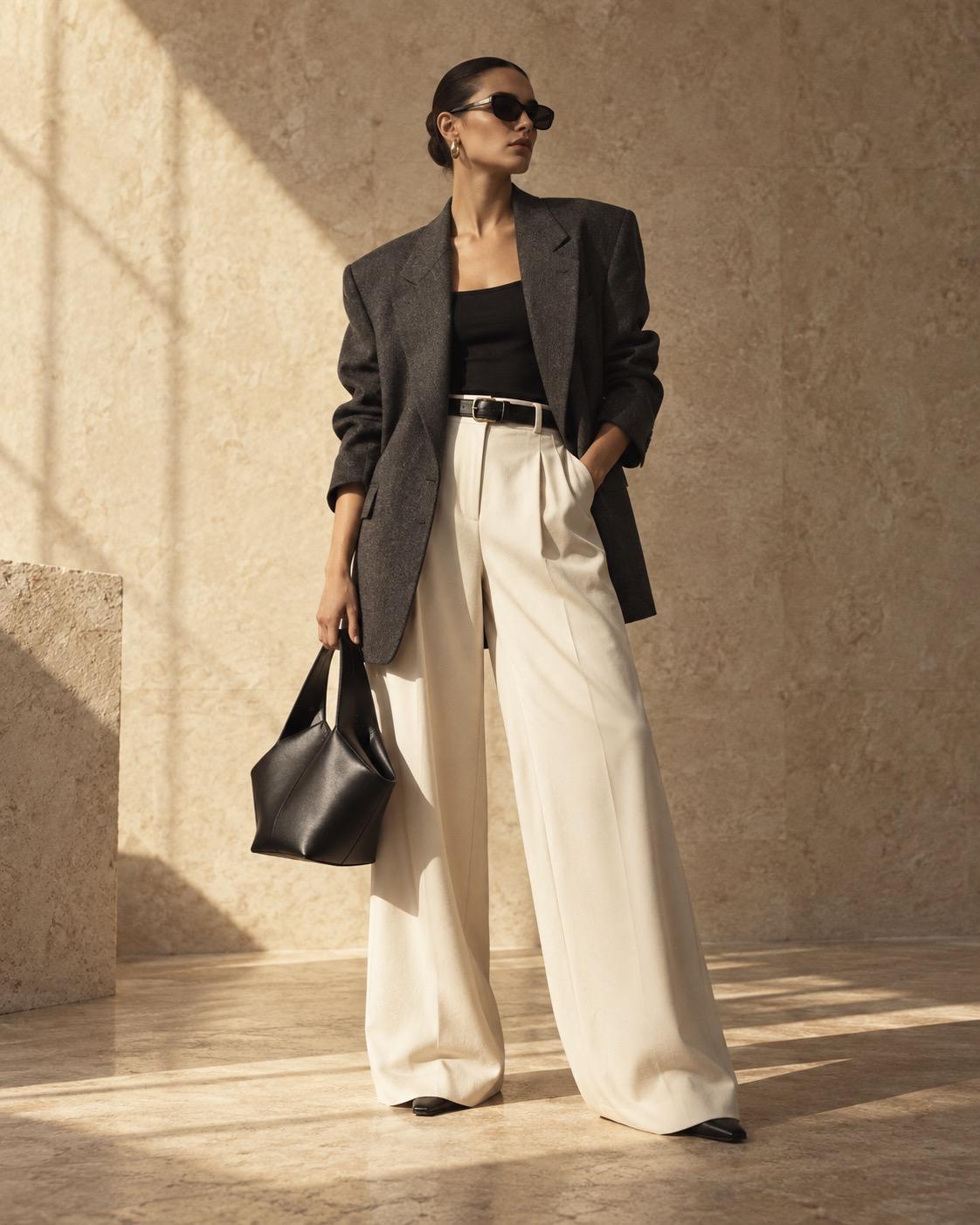 Editorial fashion portrait in a charcoal blazer and ivory tailoring